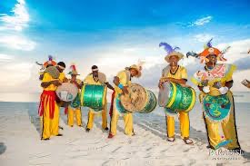 Junkanoo band in colorful costumes on the beach